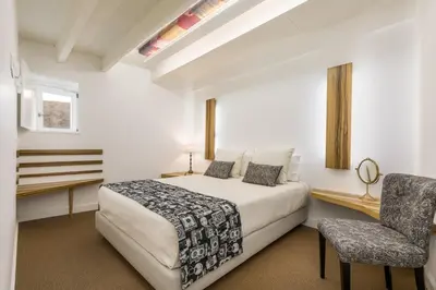 a bedroom with a bed and a desk and a chair at By the River 1 by Porto Dream Stays in Porto