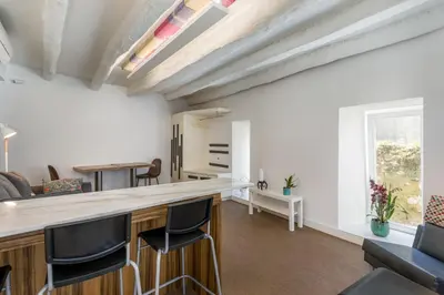 a kitchen and living room with a bar with stools at By the River 1 by Porto Dream Stays in Porto