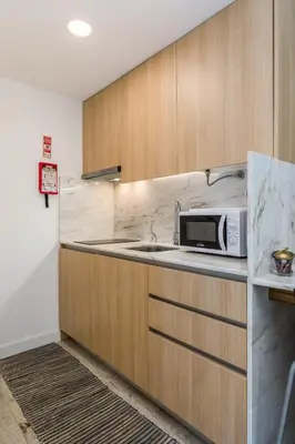 a kitchen with a sink and a microwave at By the River 1 by Porto Dream Stays in Porto
