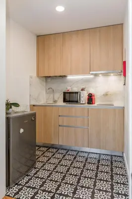 a kitchen with wooden cabinets and a sink at By the River 2 by Porto Dream Stays in Porto