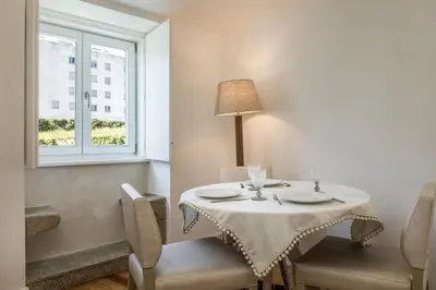 a table and chairs with a table and a window at By the River 2 by Porto Dream Stays in Porto