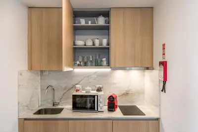 a kitchen with a sink and a microwave on a counter at By the River 2 by Porto Dream Stays in Porto