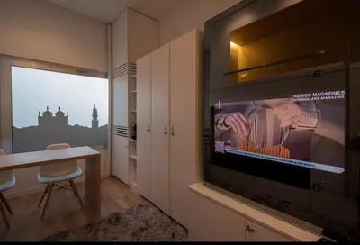 a room with a tv and a table and a window at Space Shuttle studios - Tiny House in Porto
