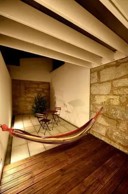 a hammock in the middle of a room with a table at Space Shuttle studios - Tiny House in Porto