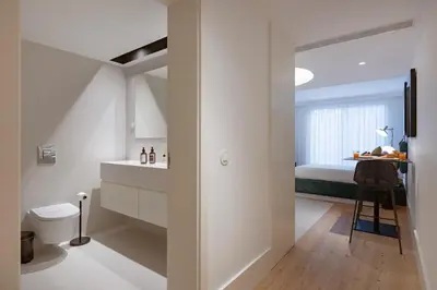 a hallway with a large mirror in a white room at Formosa City Studio in Porto