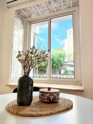 a vase sitting on a table in front of a window at Casa Moara - Downtown Duplex House in Porto