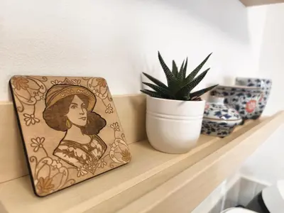 a painting of a woman sitting on a shelf with a plant at Casa Moara - Downtown Duplex House in Porto