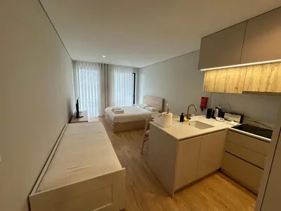 a kitchen and living room with a bed in the background at New Douro 406 with parking in Vila Nova de Gaia
