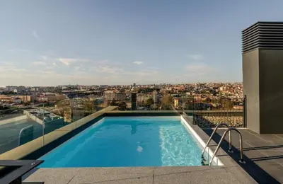 a swimming pool on the roof of a building at New Douro 406 with parking in Vila Nova de Gaia