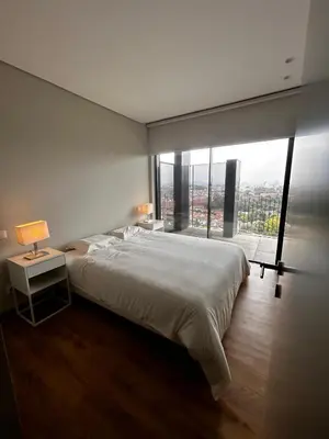 a bedroom with a large bed and a large window at New Douro 801 with parking in Vila Nova de Gaia