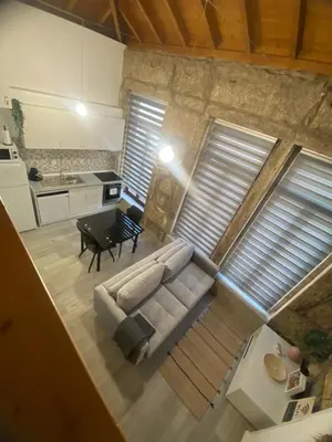 a living room with a couch and a table at Porto Saldanha - 2x T2 Duplex in Porto