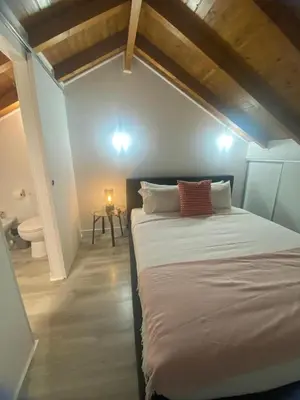 a bedroom with a large bed in a attic at Porto Saldanha - 2x T2 Duplex in Porto