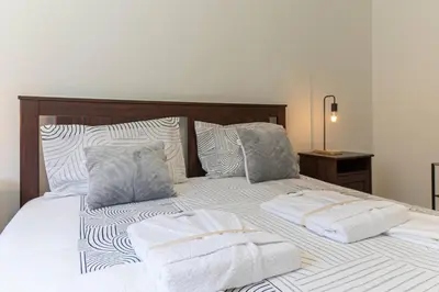 a bedroom with a bed with towels on it at Now Trindade in Porto