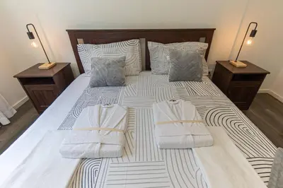 a bedroom with a bed with towels on it at Now Trindade in Porto