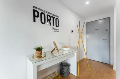 a white room with a table and a sign on the wall at GuestReady - Homey experience in Porto in Porto
