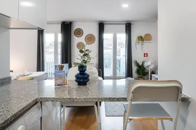 a kitchen with a counter and chairs in a room at GuestReady - Homey experience in Porto in Porto