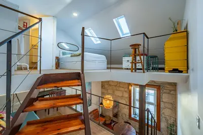 a room with a spiral staircase in a house at Essence Oporto Apartment Downtown in Porto