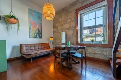a living room with a leather couch and a table at Essence Oporto Apartment Downtown in Porto