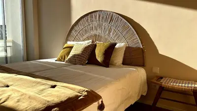 a bedroom with a large bed with a wooden headboard at BEST - Apartment with AC, Parking and Balcony in Porto