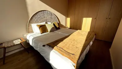 a bedroom with a large bed with a wooden headboard at BEST - Apartment with AC, Parking and Balcony in Porto