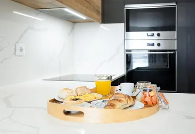 a tray of breakfast foods on a counter in a kitchen at Feel Porto Lapa Collection Flats in Porto