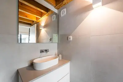 a bathroom with a sink and a mirror at GuestReady - Silk Factory Studios and Apartments in Porto