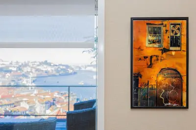 a picture hanging on a wall next to a window at Local 167 - Oporto View House in Vila Nova de Gaia