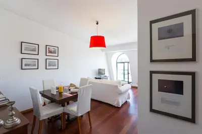 a living room with a table and a white couch at Seagull Rooftop Downtown - Light and Views in Porto