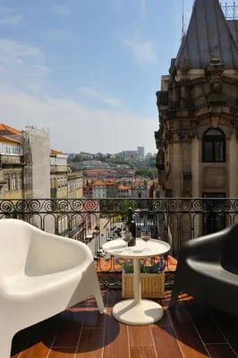 a balcony with a table and chairs and a view at Largo São Domingos by Innapartments in Porto