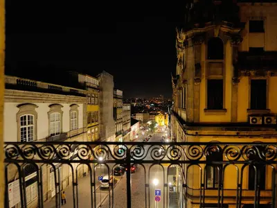 a view of a city street at night at Largo São Domingos by Innapartments in Porto