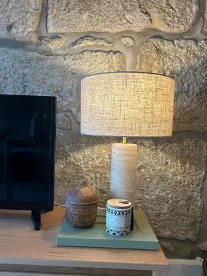 a lamp sitting on a table next to a monitor at Largo São Domingos by Innapartments in Porto