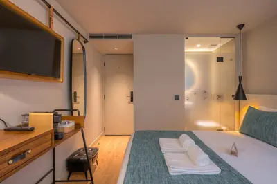 a bedroom with a bed with a tv and a shower at Carpe Diem Porto By Dualgroup in Porto