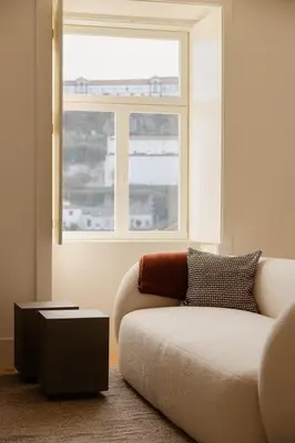 a staircase in a house with white walls and wooden floors at Oasiys - Your Getaway in Porto in Porto