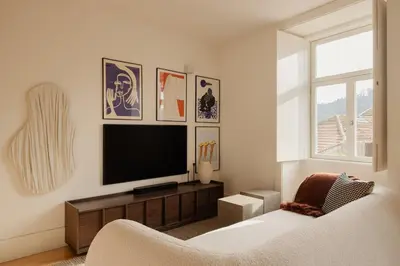 a living room with a tv and a couch at Oasiys - Your Getaway in Porto in Porto