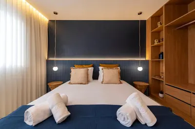 a bedroom with a large bed with two pillows at DoisPontoZero NAVY in Porto