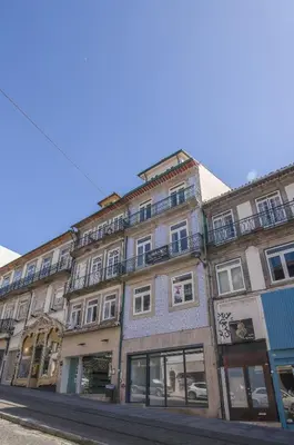 a large building on a street with windows at Portobliss Apartment in Porto