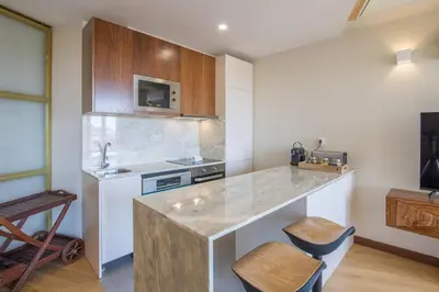 a kitchen with a counter with a sink and a stove at Portobliss Apartment in Porto