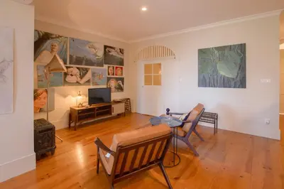 a living room with a table and chairs and paintings on the walls at Once Upon in Porto Apartment III in Porto