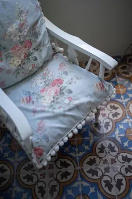 a white chair with a pillow on top of a floor at Once Upon in Porto Apartment III in Porto