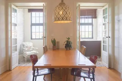 a dining room with a wooden table and chairs at Once Upon in Porto Apartment III in Porto