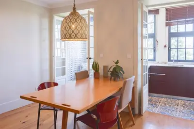 a dining room with a wooden table and chairs at Once Upon in Porto Apartment III in Porto