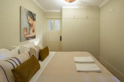 a bedroom with a large bed with towels on it at Once Upon in Porto Apartment III in Porto