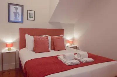 a bedroom with a large bed with two towels on it at Once Upon In Porto Apartments II in Porto