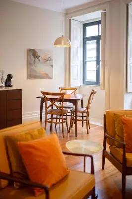 a living room with a table and chairs at Once Upon in Porto Apartments I in Porto