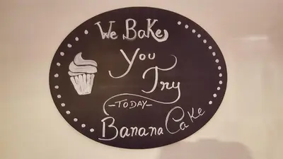 a sign that says we bake you my happy banana cake at In Porto Gallery Guesthouse in Porto