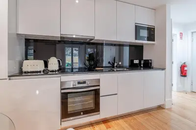 a kitchen with a sink and a counter top at Almada Prime Apartment I in Porto