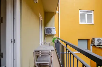 a kitchen with white cabinets and a white desk at Almada Prime Apartment I in Porto