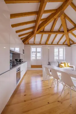 a kitchen and dining room with a table and chairs at Almada Prime Apartment II in Porto