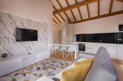a living room with a couch and a kitchen at Almada Prime Apartment II in Porto