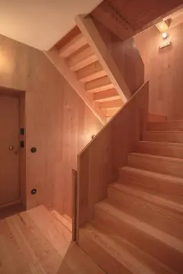 a staircase in a house with wooden walls and wooden floors at Andrade Rooftop Duplex in Porto